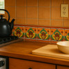 Mexican tile heart corn border handcrafted design installed on a kitchen backsplash with vibrant Mexican tones