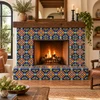 Mexican talavera tile with blue yellow medallion surrounding a rustic indoor fireplace