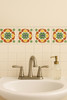Mexican talavera tile green medallion adding artisanal charm to a traditional bathroom accent wall