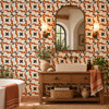 Terracotta border talavera Mexican tile on a bathroom wall with a rustic wood vanity.