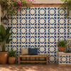 Cobalt curved flourish talavera tile decorating a patio wall in a vibrant outdoor living space