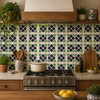 Mexican tile with dark floral Fans used as a 4x4-inch framed backsplash above a white countertop