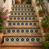 Mexican tile with dark floral fans decorating terracotta stair risers in a rustic outdoor setting