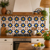 Navy daisy mexican tile featured on a rustic kitchen backsplash with natural lighting