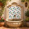 Talavera tile wtih floral tulip pattern surrounding a garden fountain with traditional floral decoration