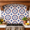Blue talavera floral medallion tile installed as kitchen backsplash in Spanish Colonial design