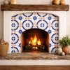 Blue talavera floral medallion tile surrounding fireplace in Spanish Revival living room