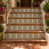 Mexican talavera tile in yellow and blue floral used on stair risers as a decorative accent.