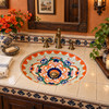 Mexican talavera lattice scrollwork bathroom sink in a colonial powder room with dark wood