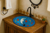 Talavera celestial moon bathroom sink placed in a Spanish Revival house with plaster walls and iron accents