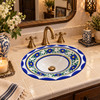 Talavera blue yellow floral sink in a boutique hotel powder room with elegant tile and brass