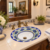 Talavera blue yellow floral sink in a colonial powder room with carved wood and artisan tile