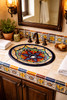 Vibrant floral talavera bathroom sink styled in a house bathroom with handmade tile and warm natural light