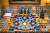 Vibrant talavera motif bathroom sink featured in a restaurant washroom creating a colorful artisanal focal point