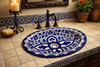 Cobalt clover talavera bathroom sink styled in a Spanish Revival bathroom with classic ceramic accents