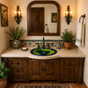 Mexican bathroom sink green frog placed on a house vanity surrounded by colorful tilework and natural textures