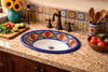 Talavera cobalt terracotta bathroom sink styled in a kitchen interior with handcrafted tile and warm light