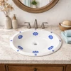 Oval blue floral talavera mexican bathroom sink set in coastal style bathroom with white plaster wall and stone countertop