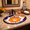 Talavera yellow floral center sink featured in a guest bathroom with soft lighting and artisan accents