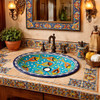 Talavera turquoise fish bathroom sink displayed in a Spanish Revival bathroom with tile and warm textures