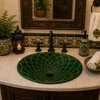 Emerald leaf talavera bathroom sink in a guest bathroom with warm ceramic tile accents.