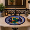 Tropical fish oval talavera bathroom sink in a Mediterranean vanity with artisan tile details.