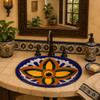 Talavera bathroom sink orange green colonial in a Spanish Revival bath with traditional tilework.
