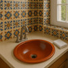Hand made rustic mexican bathroom terra cotta sink in a bathroom with Mexican tile backsplash