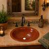 Handcrafted Mexican bathroom sink in terracotta finish adding artisan charm to a guest bathroom