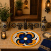 Handcrafted Mexican bathroom sink with blue and orange petal design in a Spanish Revival vanity