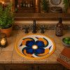 Oval ceramic Mexican sink with blue and orange petal design installed in a rustic kitchen bar