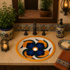 Blue and orange petal Mexican bathroom sink showcased in a warm hacienda-style bathroom vanity