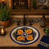 Hand-painted cobalt blue Mexican bathroom sink installed in a rustic kitchen bar with tile countertop.