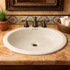 Mexican oval off white talavera bathroom sink featured in Hacienda restaurant restroom with decorative tile accent