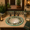 Elegant Mexican bathroom sink with green scrollwork enhancing a Hacienda-style house bathroom.
