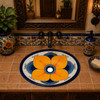 Mexican bathroom sink in artisan floral style displayed in a hacienda house bathroom with handcrafted tile accents.