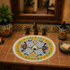 Mexican bathroom sink with colorful artisan patterns displayed in a hacienda style house with handcrafted tile vanity
