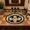 Talavera sink with a hand painted blue medallion design in a Spanish Revival bathroom vanity with handcrafted Talavera tile countertop.