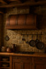 78 inch barrel copper range hood in a rustic kitchen