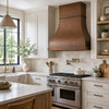Hammered copper range hood in a bright modern farmhouse kitchen with painted cabinets, pale oak, apron sink and handmade tile