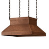 Chain suspended copper island range hood in Victorian style front view with light patina hammered copper canopy on a white background