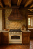 Copper range hood in rustic kitchen, handcrafted metal canopy above stone backsplash, exposed timber beams and natural wood cabinetry