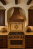 Old European copper range hood with decorative scroll motif in Spanish Revival kitchen, hammered copper canopy with warm patina finish and handcrafted detailing