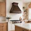 Minimalist trapezoidal copper range hood with deep apron in California transitional kitchen