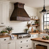 Minimalist trapezoidal copper range hood with deep apron in modern farmhouse kitchen