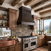 Bright mountain lodge kitchen with reclaimed beams and dark hammered copper range hood