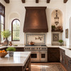 Spanish Colonial Revival kitchen with dark hammered copper range hood, carved wood cabinets, and arched window