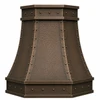 Angled faceted copper island range hood with riveted straps showing dimensional hammered panels