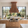Custom embossed apron copper range hood with bell canopy in luxury rustic kitchen