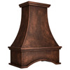 Angled view of hand hammered copper range hood with deep concave apron